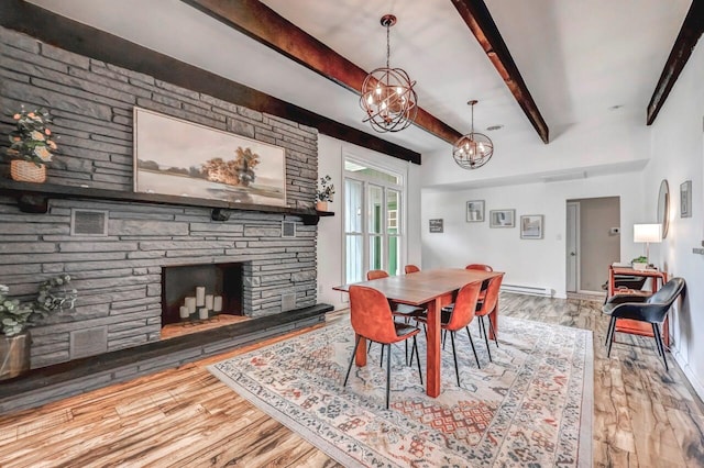 134 Altemose Rd, Pocono Lake, PA 18347 - dining space featuring a stone fireplace, wood finished floors, beam ceiling, a baseboard heating unit, and a chandelier