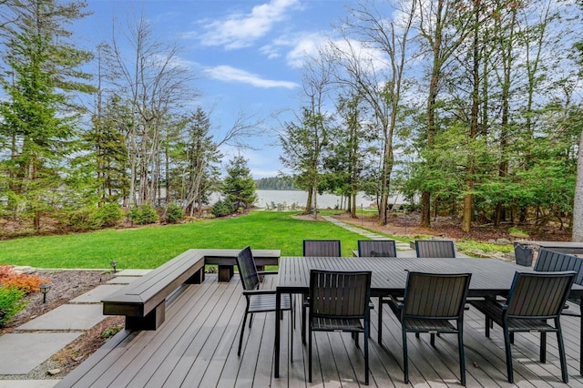 deck featuring a lawn, a water view, and outdoor dining area