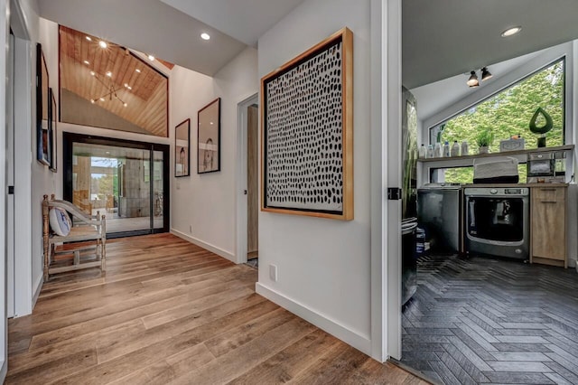 hall featuring plenty of natural light, recessed lighting, baseboards, and vaulted ceiling