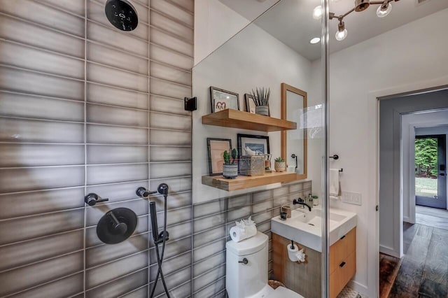 bathroom featuring toilet, wood finished floors, and vanity