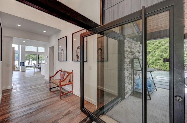 interior space featuring baseboards, recessed lighting, and wood finished floors