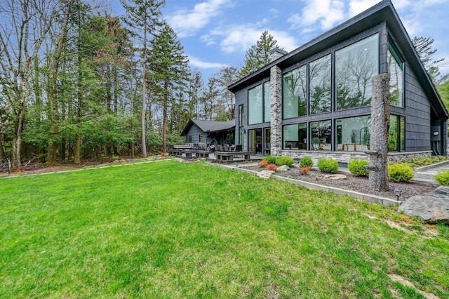 rear view of property featuring a lawn