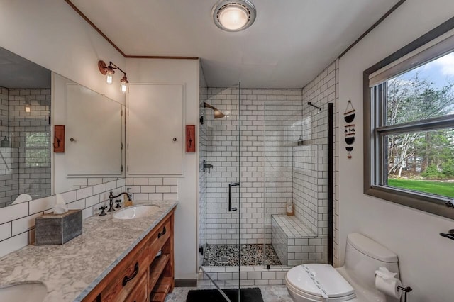 full bathroom featuring a sink, toilet, double vanity, backsplash, and a stall shower
