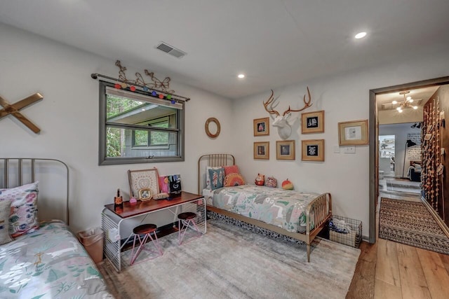 bedroom featuring wood-type flooring, recessed lighting, a chandelier, and visible vents