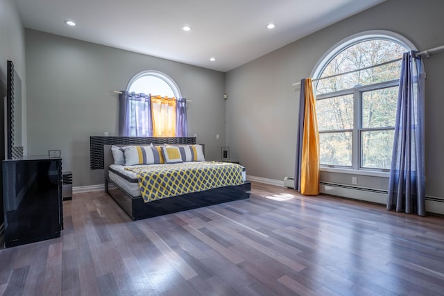 bedroom with baseboards, multiple windows, recessed lighting, and wood finished floors