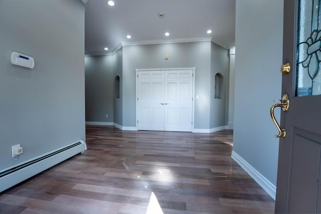 foyer featuring crown molding, arched walkways, baseboards, and a baseboard radiator