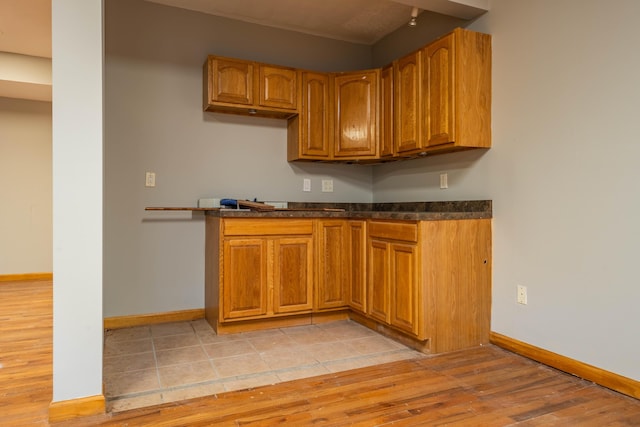 bar featuring baseboards and light wood-style floors