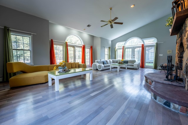 living area featuring french doors, a ceiling fan, wood finished floors, and high vaulted ceiling