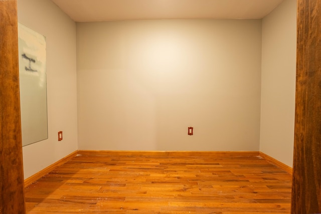 empty room featuring baseboards and wood finished floors