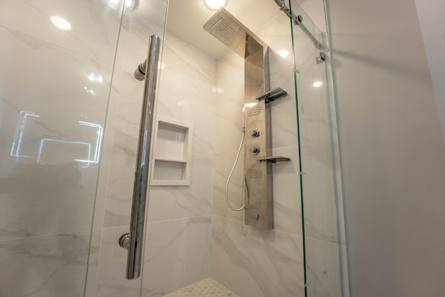 bathroom with a marble finish shower