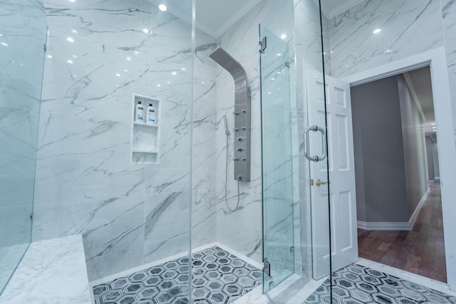 bathroom featuring ornamental molding and a marble finish shower