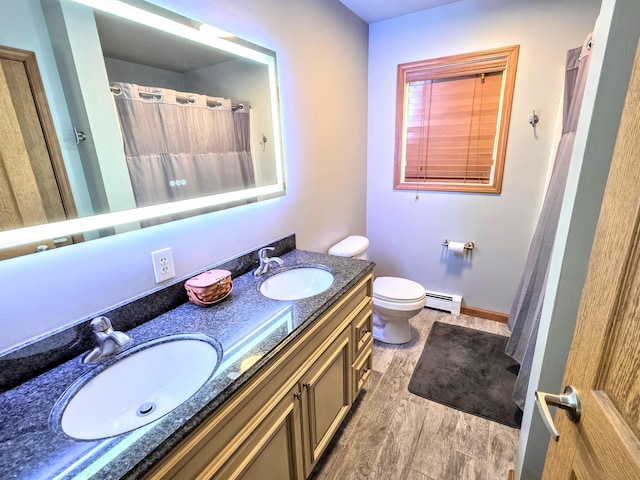 1277 Cherry Hill Rd, Palmerton, PA 18071 - full bath featuring a baseboard heating unit, double vanity, toilet, wood finished floors, and baseboards