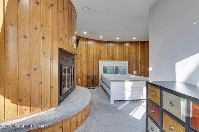 123 Shannon Ct, Bushkill, PA 18324 - bedroom featuring light colored carpet, recessed lighting, wood walls, and a glass covered fireplace