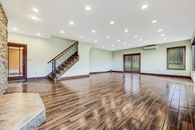 374 Packer Dr, Weatherly, PA 18255 - unfurnished living room with wood finished floors, baseboards, and an AC wall unit