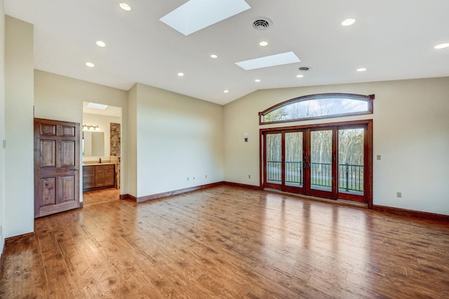 374 Packer Dr, Weatherly, PA 18255 - empty room with baseboards, recessed lighting, visible vents, lofted ceiling with skylight, and wood finished floors
