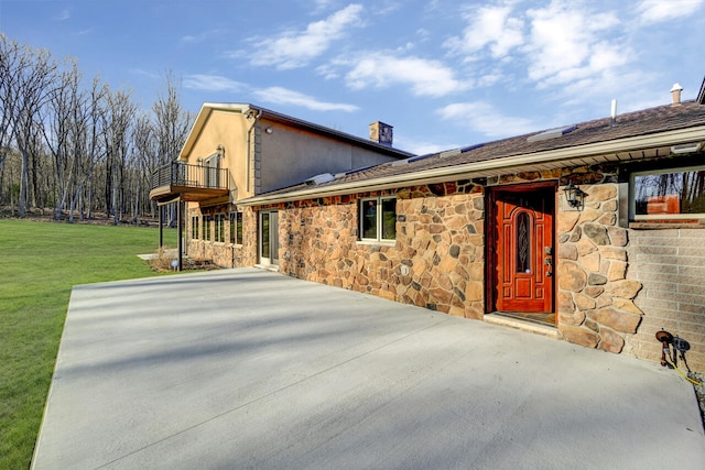 374 Packer Dr, Weatherly, PA 18255 - exterior space featuring a patio area, stone siding, a lawn, a chimney, and a balcony