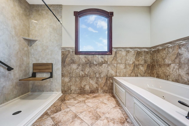 374 Packer Dr, Weatherly, PA 18255 - bathroom with a jetted tub, tiled shower, and tile walls