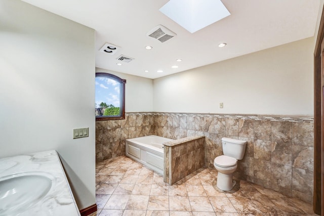 374 Packer Dr, Weatherly, PA 18255 - full bathroom featuring a sink, visible vents, a skylight, tile walls, and a garden tub