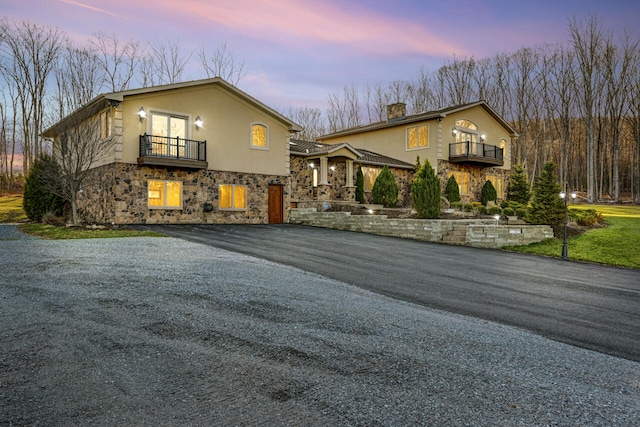 374 Packer Dr, Weatherly, PA 18255 - view of front of home with driveway, stucco siding, stone siding, and a balcony