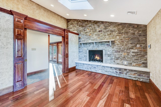 374 Packer Dr, Weatherly, PA 18255 - unfurnished living room with recessed lighting, a fireplace, visible vents, lofted ceiling with skylight, and wood-type flooring