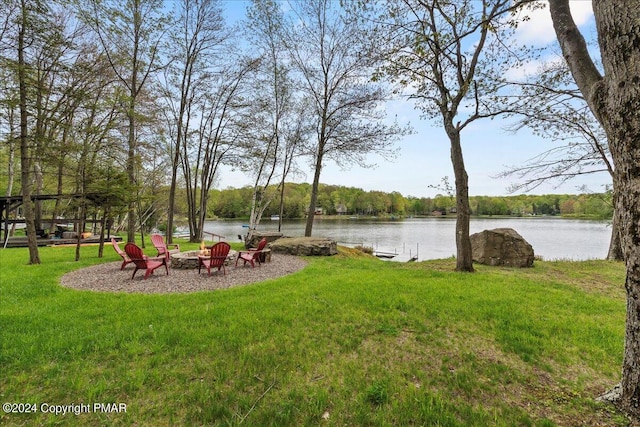 view of yard with a water view and an outdoor fire pit