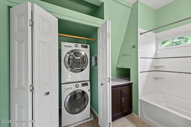 clothes washing area with stacked washer / dryer