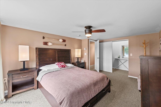 bedroom featuring carpet floors, a closet, baseboards, and a ceiling fan