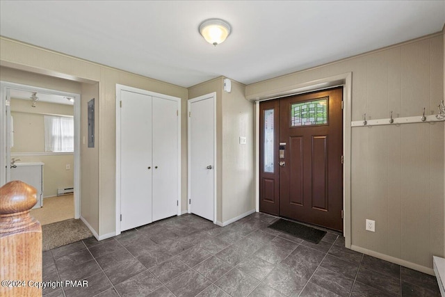 entryway featuring plenty of natural light, a baseboard heating unit, and baseboards