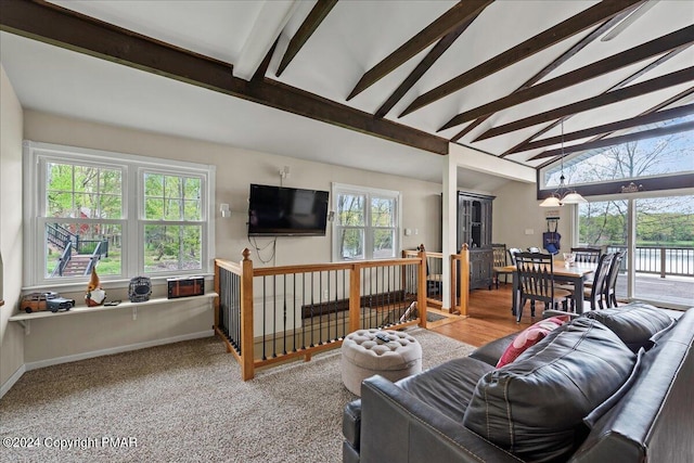 living room featuring vaulted ceiling with beams and baseboards