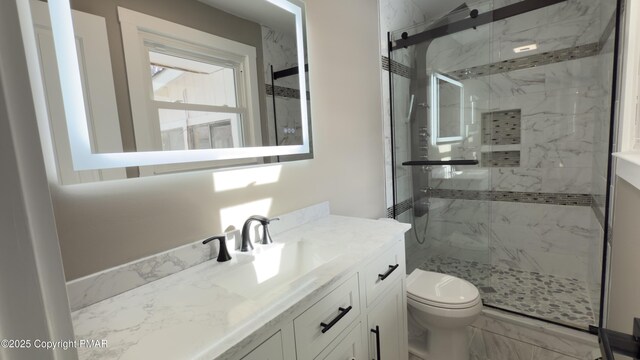 bathroom with vanity, toilet, and walk in shower