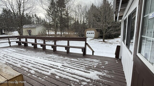 snow covered deck featuring a storage unit