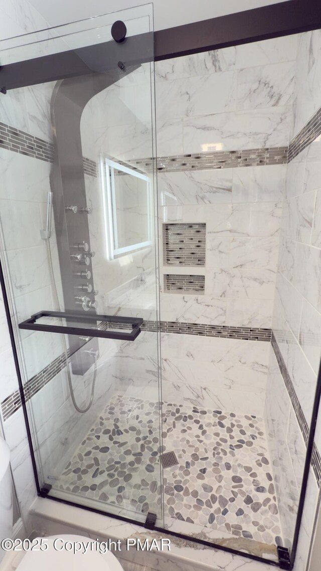 bathroom with a shower with shower door