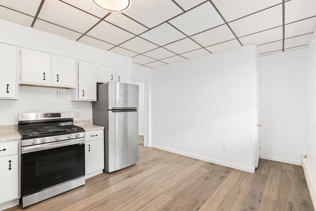 69 Hutson St, Wilkes Barre, PA 18702 - kitchen with appliances with stainless steel finishes, light countertops, light wood finished floors, white cabinetry, and baseboards