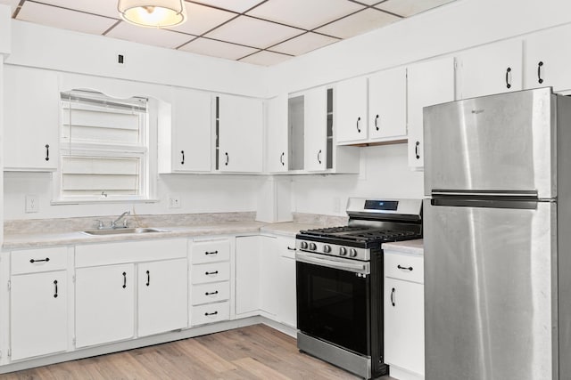 69 Hutson St, Wilkes Barre, PA 18702 - kitchen featuring appliances with stainless steel finishes, a sink, light countertops, white cabinetry, and light wood finished floors