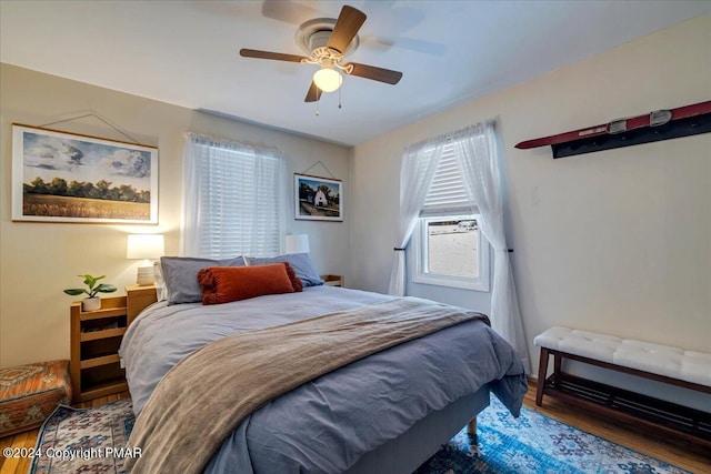 bedroom featuring a ceiling fan and wood finished floors