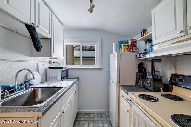 kitchen with premium range hood, white appliances, a sink, and white cabinetry