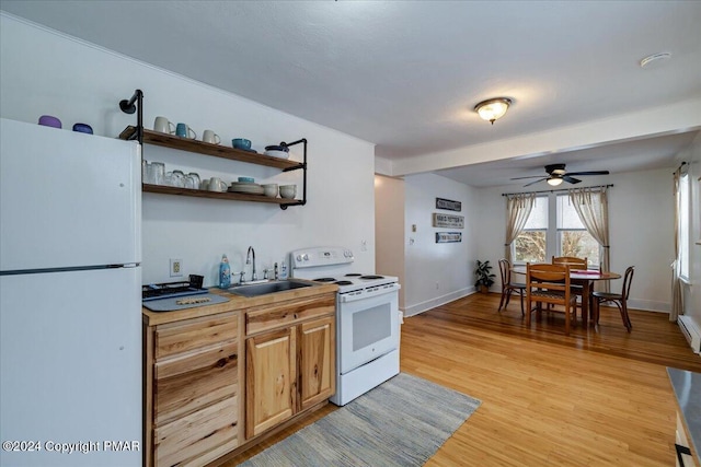 kitchen with white appliances, baseboards, light wood-style flooring, open shelves, and a sink