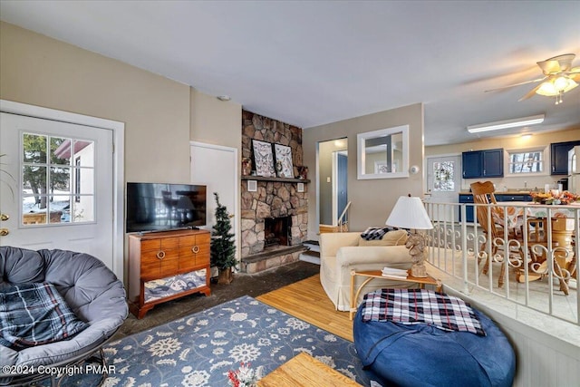 living room with a fireplace and wood finished floors