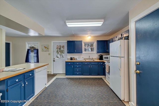 kitchen with a sink, light countertops, white appliances, and blue cabinetry