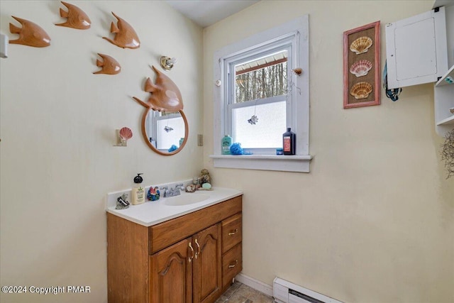 bathroom featuring baseboards, baseboard heating, and vanity