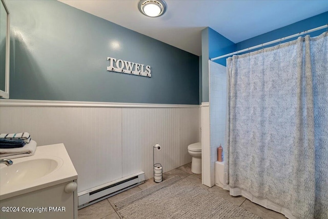 full bathroom with a baseboard radiator, tile patterned flooring, toilet, wainscoting, and shower / bath combo with shower curtain