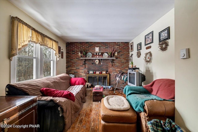 living area with a fireplace and wood finished floors