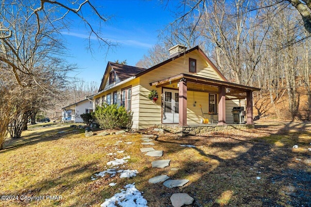 view of front of house with a porch and a chimney