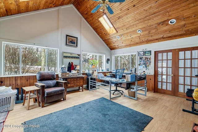 office space with high vaulted ceiling, a skylight, wood finished floors, wood ceiling, and french doors