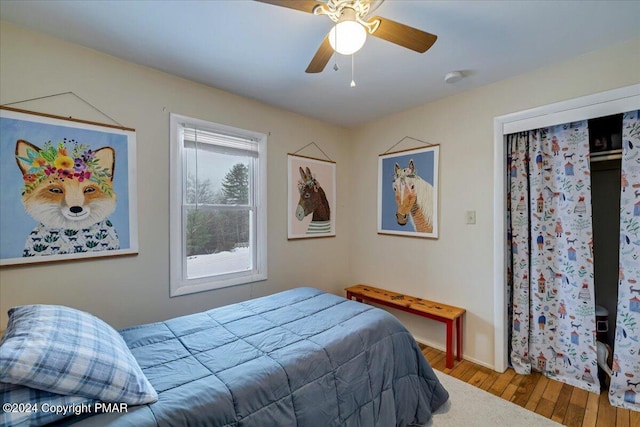 bedroom with a ceiling fan and wood finished floors