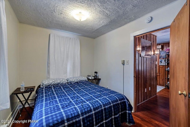 bedroom featuring a textured ceiling and wood finished floors