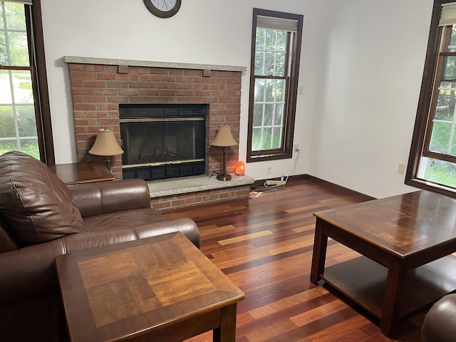 3813 Foxborough Ct, Stroudsburg, PA 18360 - living room featuring dark wood-style floors, a brick fireplace, and plenty of natural light