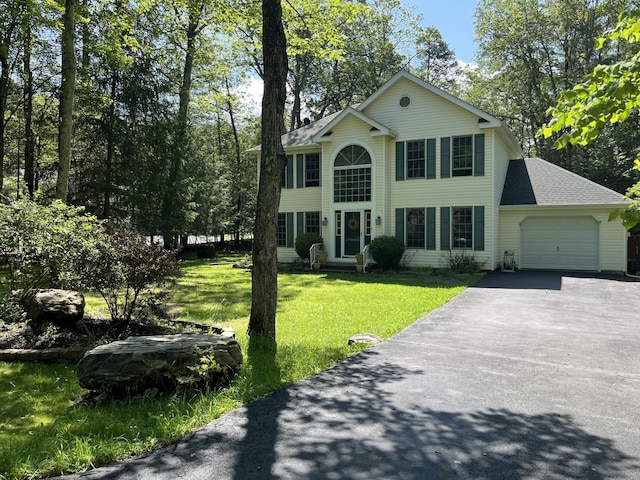 3813 Foxborough Ct, Stroudsburg, PA 18360 - colonial house featuring an attached garage, driveway, a front lawn, and a shingled roof