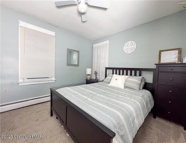 carpeted bedroom featuring ceiling fan and a baseboard heating unit