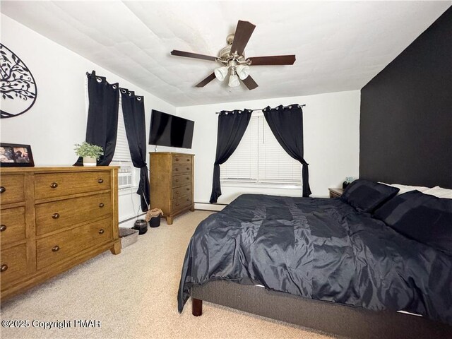 carpeted bedroom with ceiling fan and a baseboard radiator